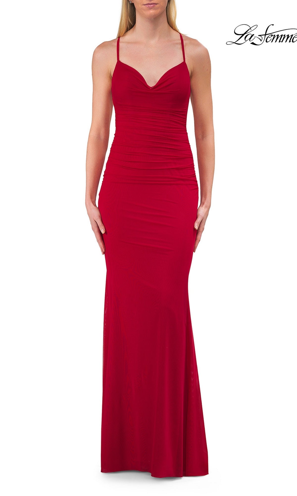 A woman wears the Sheer-Sides Long Prom Dress, La Femme 33708, in red—a sleeveless, floor-length gown featuring thin straps and a fitted bodice. The strappy open-back design adds an elegant touch against the plain white background.